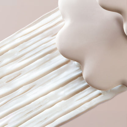 Gros plan d'une surface lisse, de couleur beige, avec un effet de flou artistique.